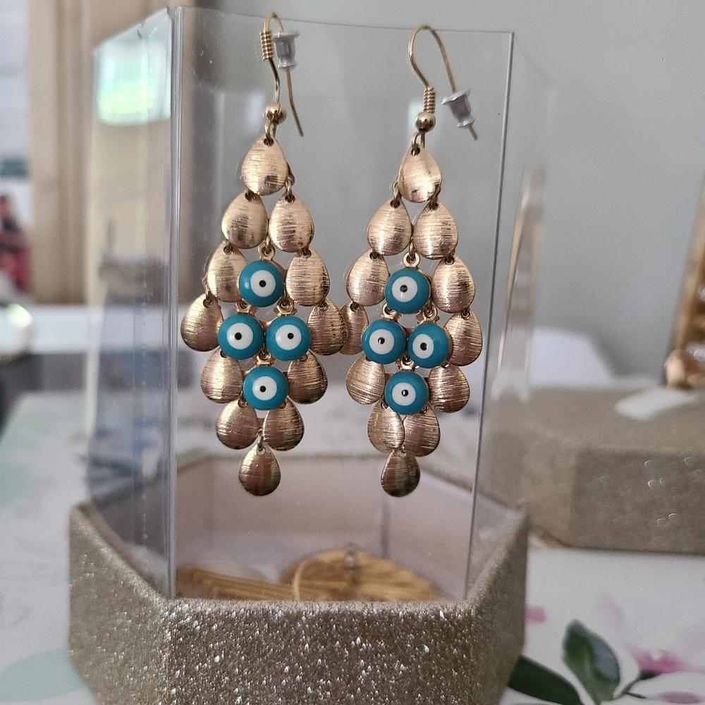 Gold dangling scallop evil eye earrings